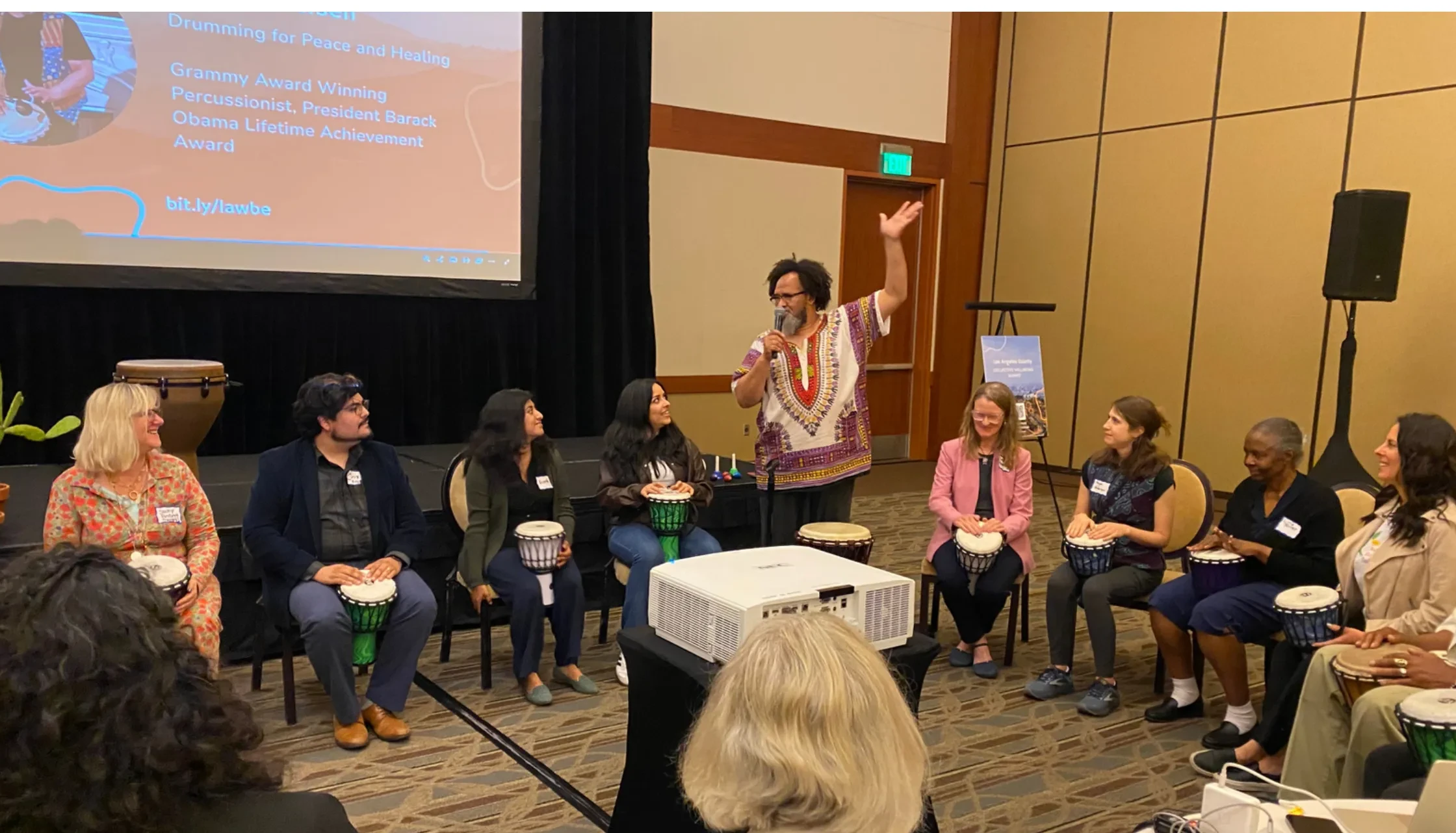 Danny Petersen leads a drumming circle at the LA County Collective Wellbeing Summit